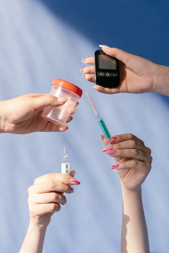 Services Collection of hands holding medical tools for diabetes management including glucometer and syringe.